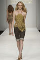 Gold chain halter top (Scott Wilson for Gharani Strok) and cocoa denim knee-length shorts  